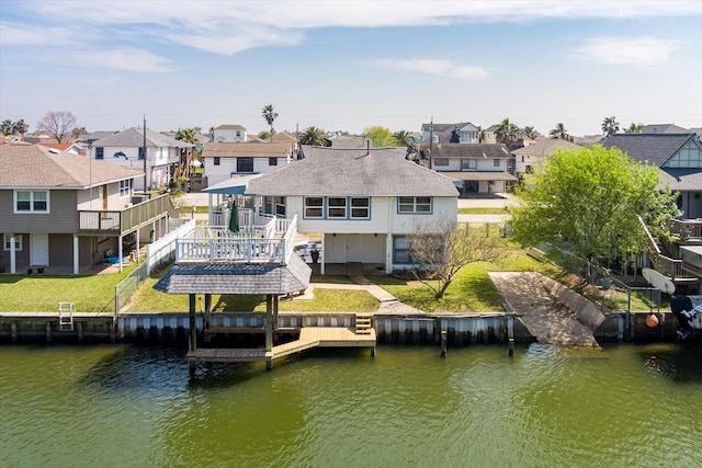 view of dock with a residential view, a yard, a deck with water view, and stairway