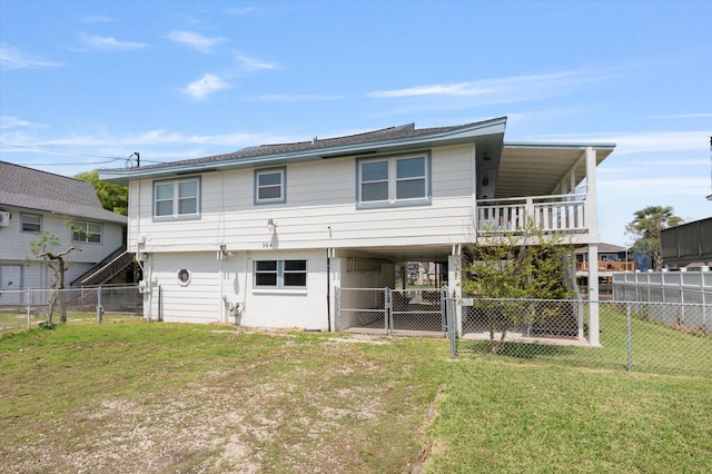 rear view of property with a yard, a fenced backyard, and a carport