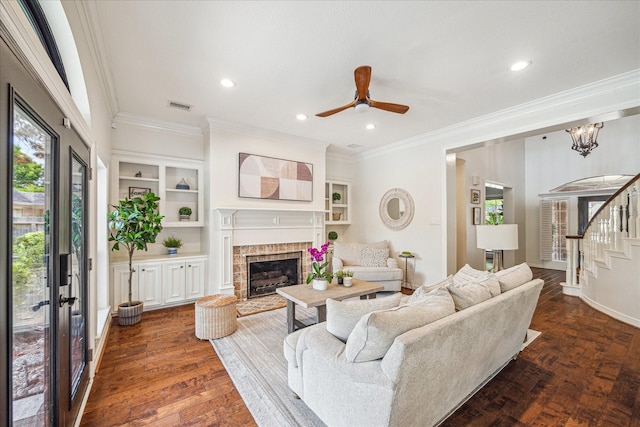 3410 Creekstone Dr, Sugar Land, TX 77479 - living room featuring ornamental molding, a fireplace with raised hearth, recessed lighting, a ceiling fan, and dark wood-style flooring