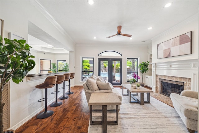 3410 Creekstone Dr, Sugar Land, TX 77479 - living area featuring wood-type flooring, recessed lighting, a fireplace with flush hearth, ceiling fan, and crown molding