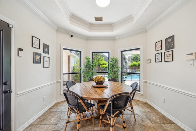 3410 Creekstone Dr, Sugar Land, TX 77479 - dining room with stone tile floors, ornamental molding, baseboards, and a tray ceiling