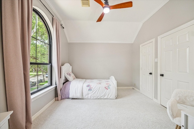 3410 Creekstone Dr, Sugar Land, TX 77479 - carpeted bedroom featuring lofted ceiling, multiple windows, baseboards, ornamental molding, and a ceiling fan