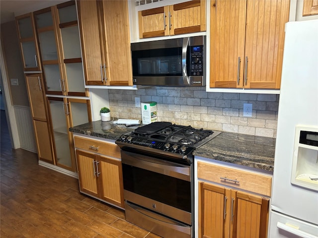 kitchen featuring decorative backsplash, dark wood-style flooring, appliances with stainless steel finishes, and brown cabinets