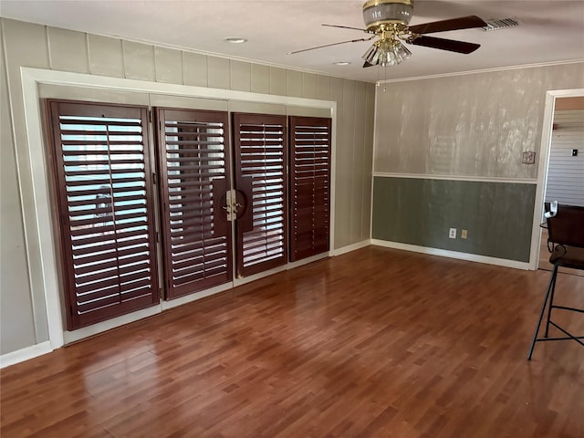 unfurnished living room featuring crown molding and wood finished floors
