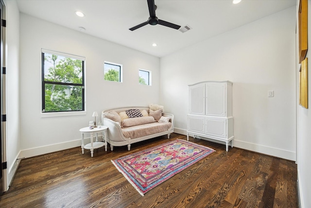 living area featuring a ceiling fan, visible vents, baseboards, recessed lighting, and dark wood-type flooring