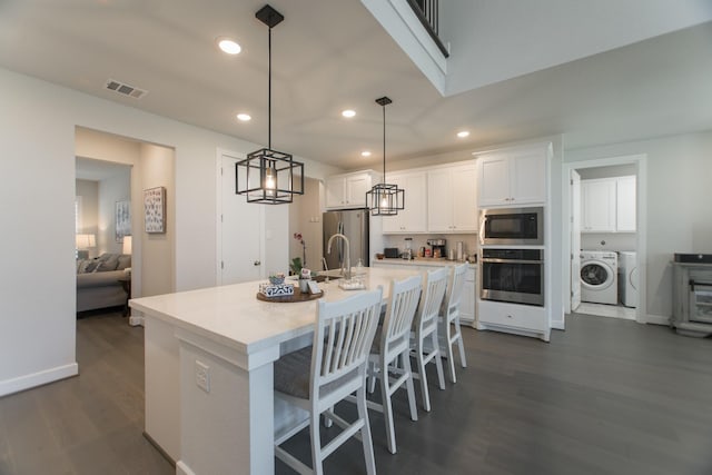 71 Perennial Canyon Dr, Tomball, TX 77375 - kitchen featuring appliances with stainless steel finishes, recessed lighting, white cabinetry, dark wood-type flooring, and light countertops