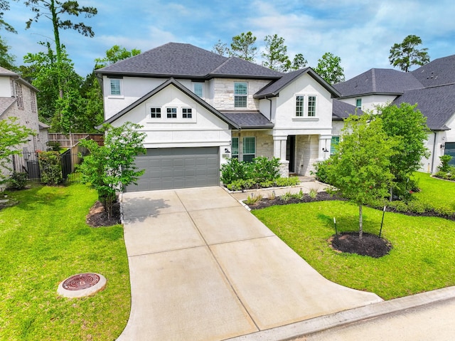 view of front of home featuring fence, a front lawn, stone siding, stucco siding, and concrete driveway