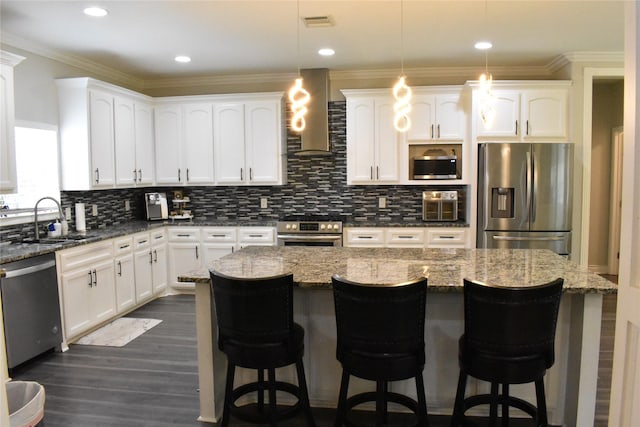 kitchen featuring a sink, wall chimney exhaust hood, tasteful backsplash, and stainless steel appliances
