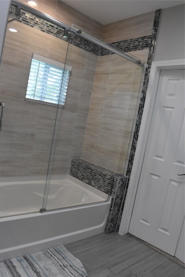 full bathroom featuring combined bath / shower with glass door