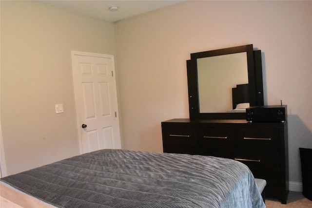 bedroom with baseboards and carpet flooring