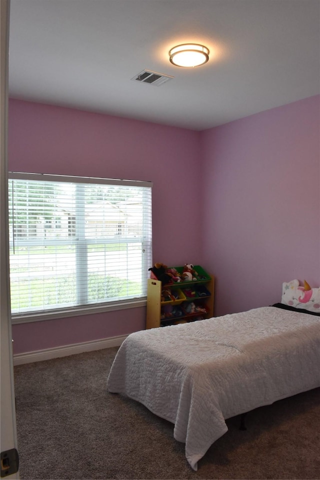 carpeted bedroom with baseboards and visible vents