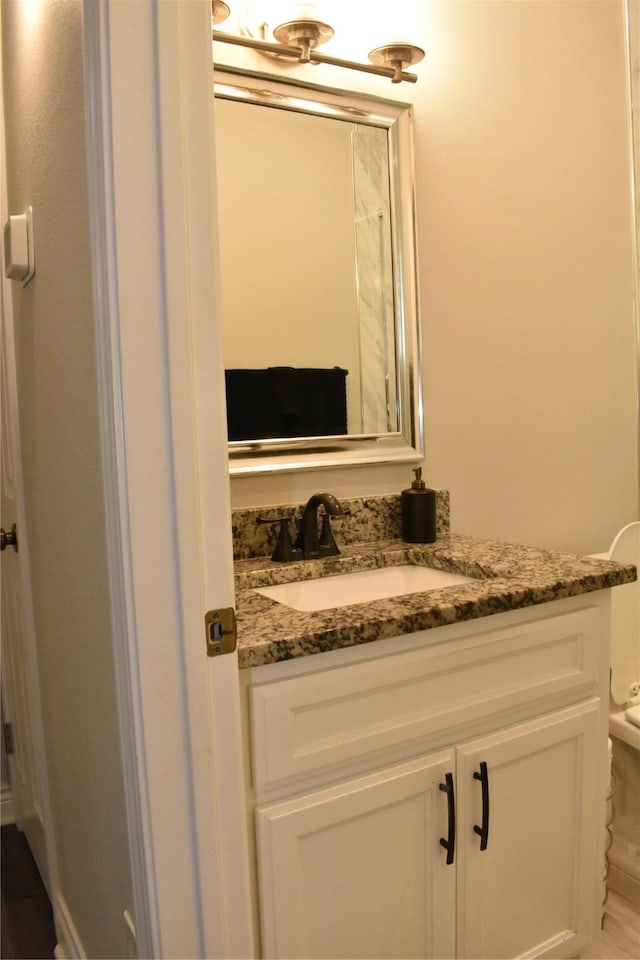 bathroom with toilet and vanity