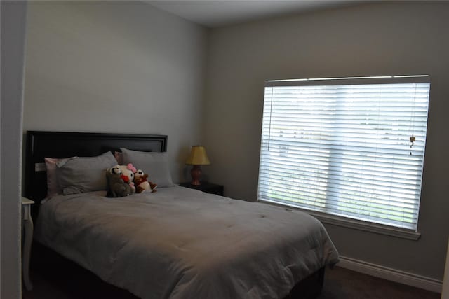 carpeted bedroom with baseboards
