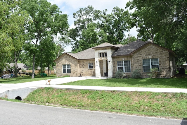 view of front of property with brick siding and a front lawn