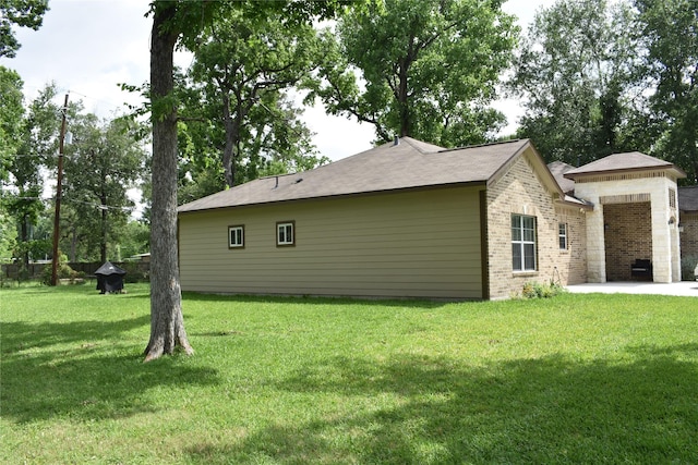 back of property with brick siding and a yard