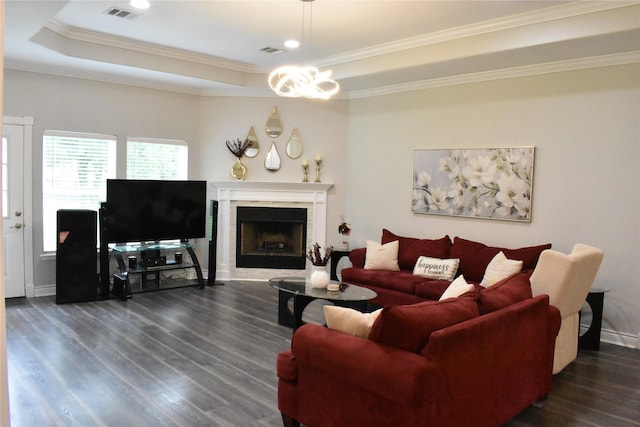 living area featuring visible vents, ornamental molding, a raised ceiling, and dark wood-type flooring