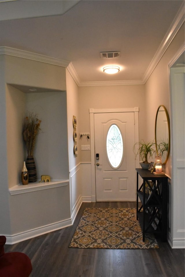 foyer entrance featuring crown molding, visible vents, and dark wood-type flooring
