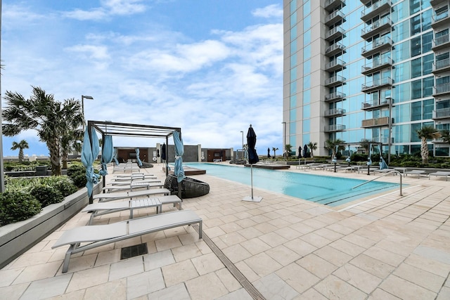 community pool with a patio and a pergola