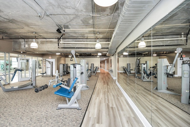 workout area with wood finished floors