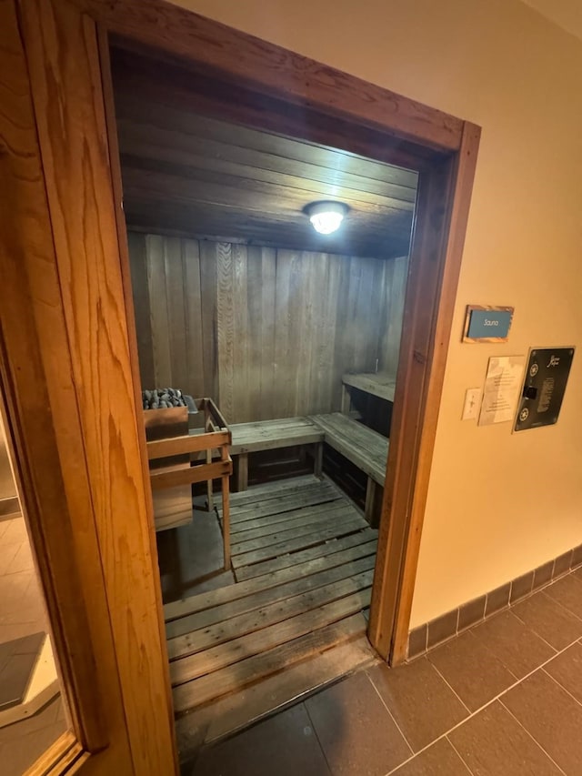 view of sauna / steam room with baseboards and tile patterned flooring