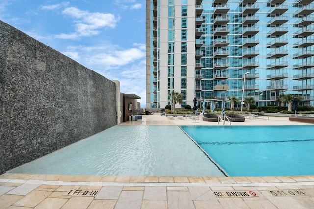 community pool featuring a patio area