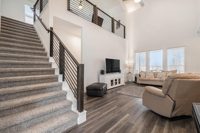13716 Rising Sun Ln, Conroe, TX 77384 - living area featuring stairs, a high ceiling, and dark wood-style flooring