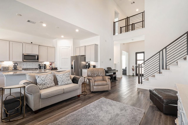 13716 Rising Sun Ln, Conroe, TX 77384 - living area with dark wood-type flooring, stairway, a high ceiling, and recessed lighting