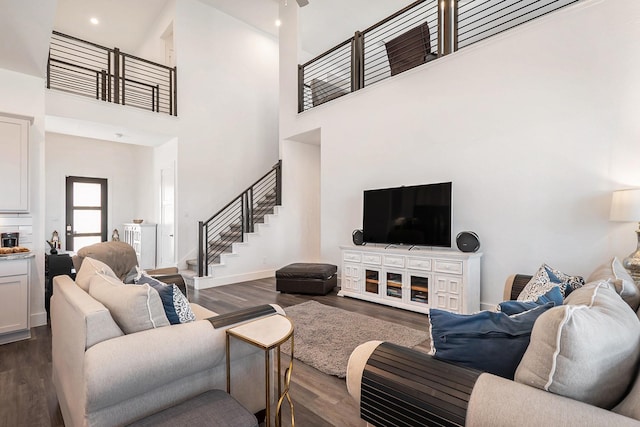 13716 Rising Sun Ln, Conroe, TX 77384 - living area with dark wood-style floors, stairway, and a high ceiling