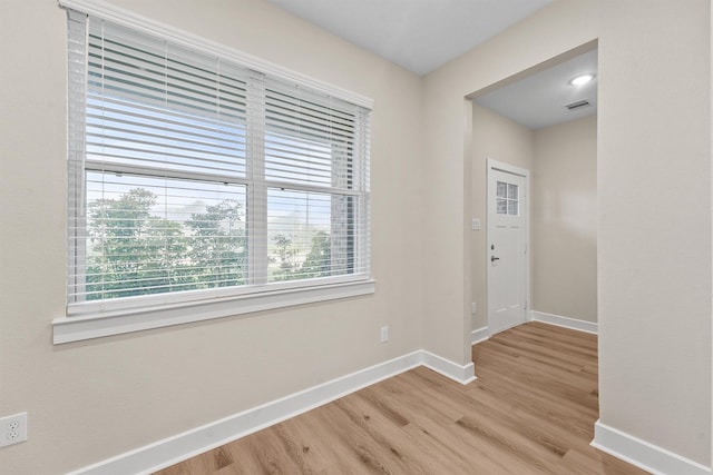 12341 N Chestnut Hills Dr, Conroe, TX 77303 - spare room featuring baseboards, visible vents, plenty of natural light, and light wood-style flooring
