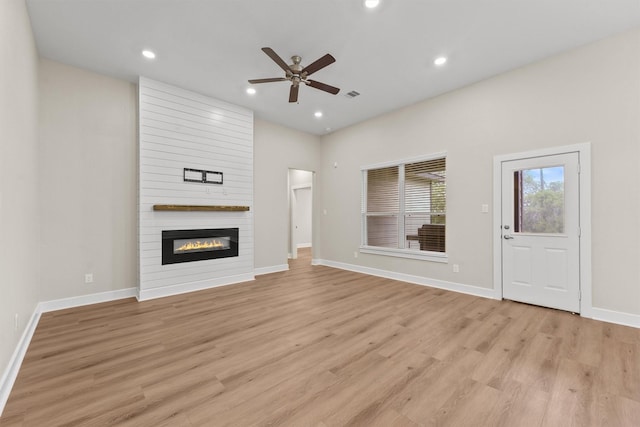 12341 N Chestnut Hills Dr, Conroe, TX 77303 - unfurnished living room featuring recessed lighting, a fireplace, a ceiling fan, and light wood-type flooring