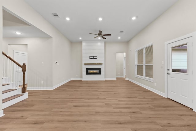 12341 N Chestnut Hills Dr, Conroe, TX 77303 - unfurnished living room featuring visible vents, ceiling fan, stairway, recessed lighting, and light wood-type flooring