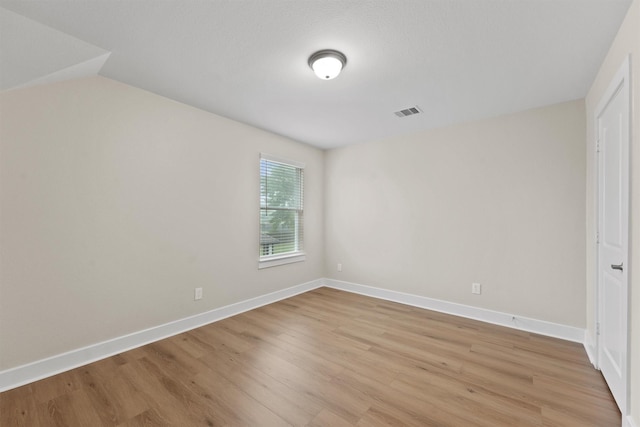 12341 N Chestnut Hills Dr, Conroe, TX 77303 - unfurnished bedroom featuring light wood-style floors, baseboards, visible vents, and vaulted ceiling