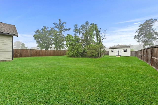 12341 N Chestnut Hills Dr, Conroe, TX 77303 - view of yard with a fenced backyard, a storage unit, and an outbuilding