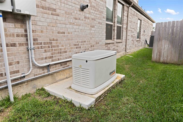 exterior details with fence, a power unit, and brick siding