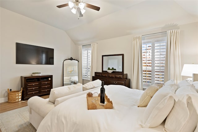 bedroom with baseboards, a ceiling fan, vaulted ceiling, and wood finished floors