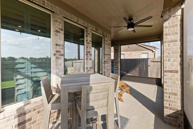 view of patio / terrace with fence, a ceiling fan, and outdoor dining space