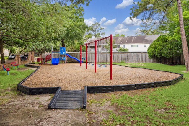community playground with a lawn and fence