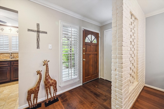 foyer featuring baseboards, ornamental molding, and hardwood / wood-style flooring