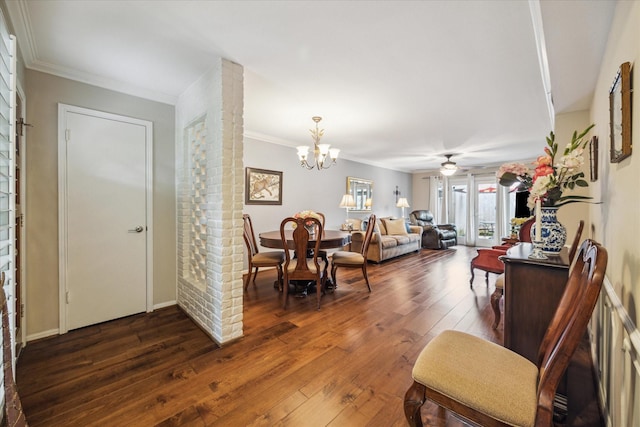 living room featuring dark wood finished floors, ornamental molding, and ceiling fan with notable chandelier