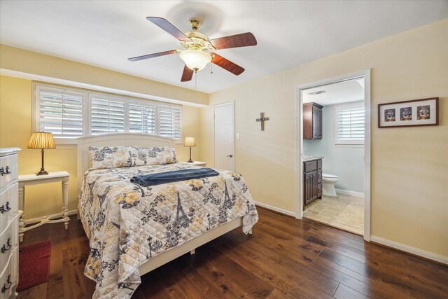 bedroom featuring baseboards, a ceiling fan, hardwood / wood-style floors, and connected bathroom