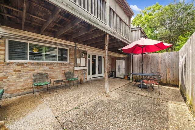 view of patio / terrace featuring fence and french doors