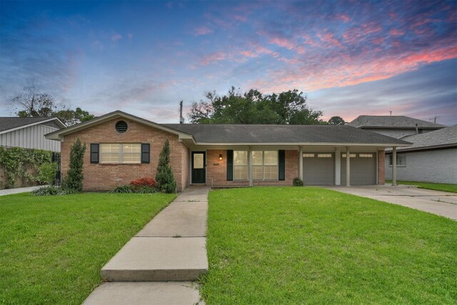 5415 Wigton Dr, Houston, TX 77096 - ranch-style home featuring brick siding, an attached garage, a yard, and concrete driveway