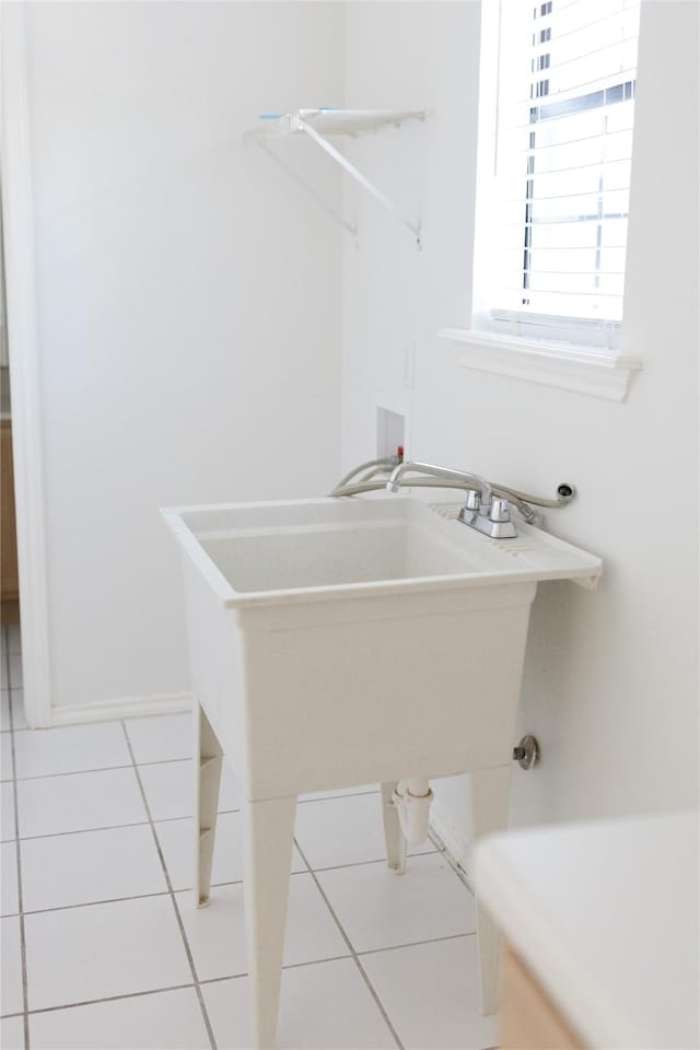 clothes washing area with laundry area, tile patterned flooring, and hookup for a washing machine