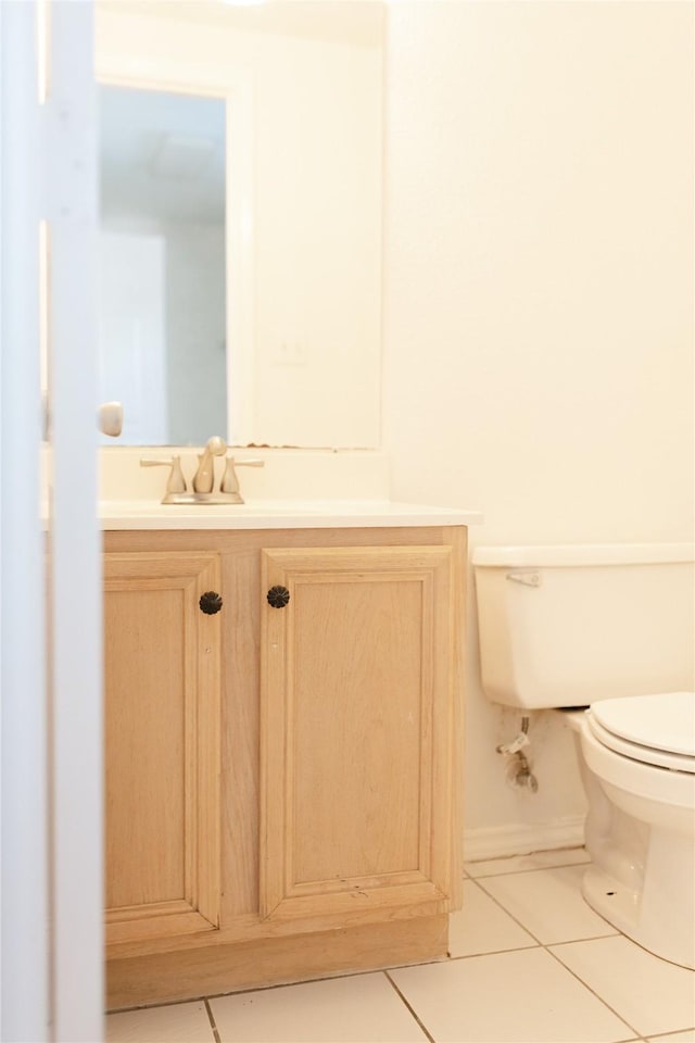 bathroom featuring vanity, toilet, and tile patterned floors