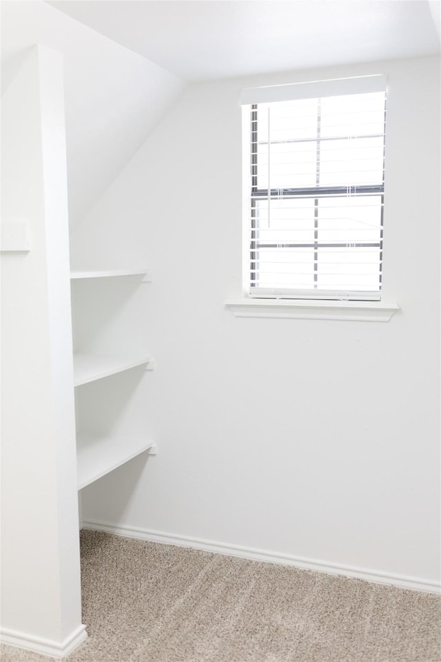 bonus room with vaulted ceiling, carpet, and baseboards