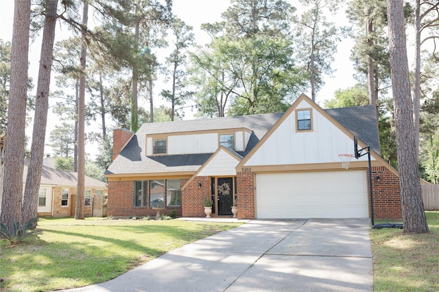 traditional-style home with a garage, a chimney, concrete driveway, a front yard, and brick siding