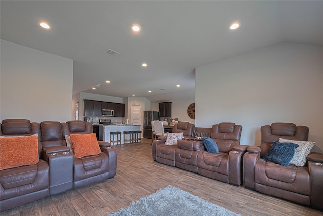 3923 Hawaiian Ct, Baytown, TX 77521 - living area featuring light wood-style flooring, recessed lighting, and vaulted ceiling
