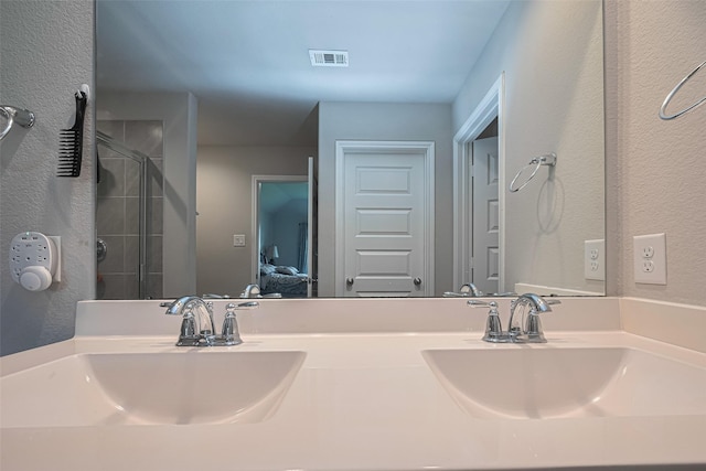 3923 Hawaiian Ct, Baytown, TX 77521 - ensuite bathroom featuring a stall shower, a textured wall, and double vanity