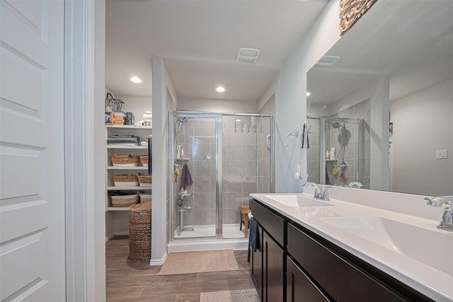 3923 Hawaiian Ct, Baytown, TX 77521 - full bathroom with a shower stall, wood finished floors, double vanity, and recessed lighting