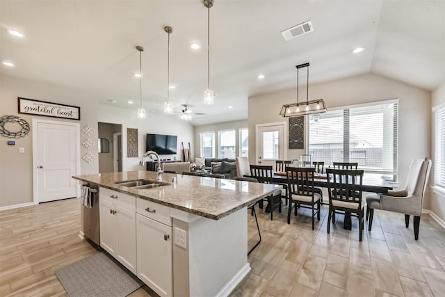 4711 Bartagrass Dr, Rosenberg, TX 77469 - kitchen with a sink, dishwasher, light wood-style floors, an island with sink, and visible vents